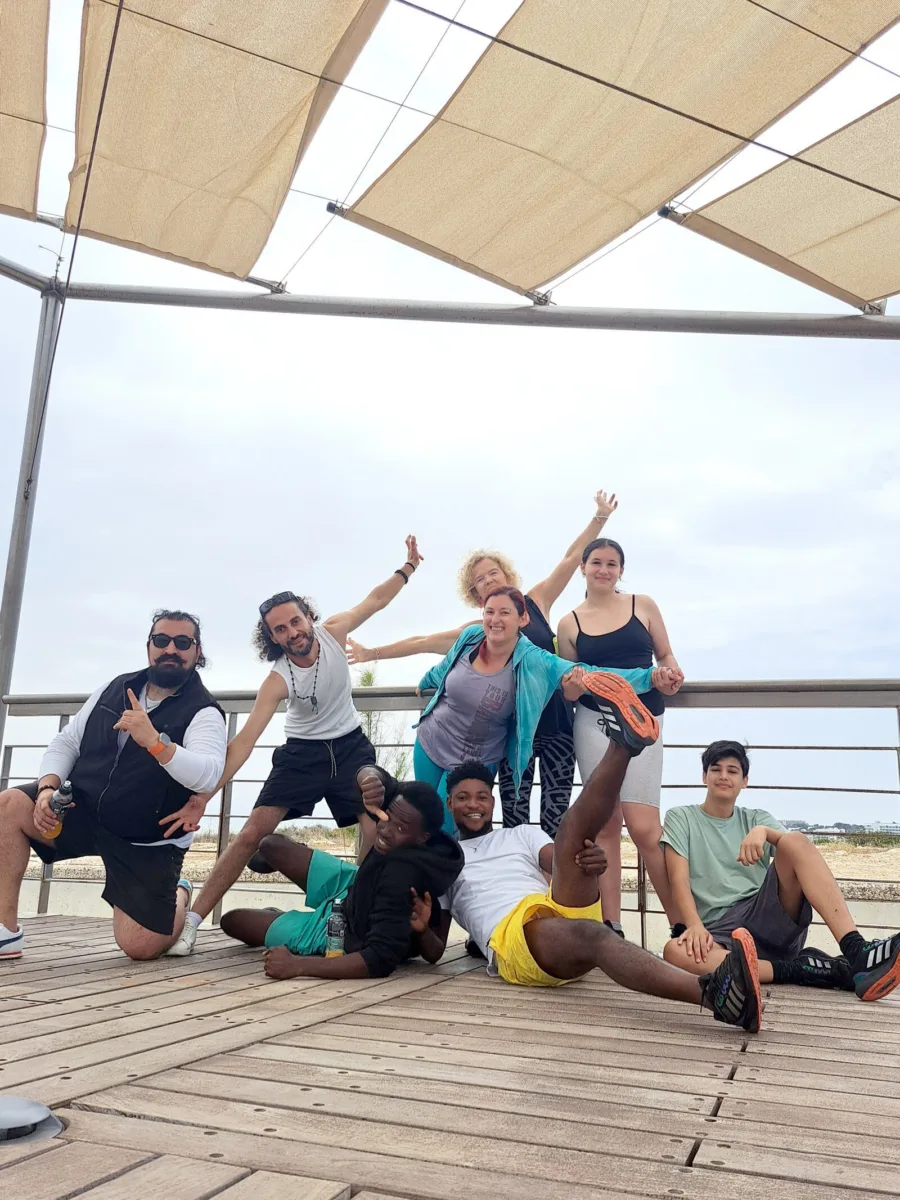 The group celebrating on the boardwalk at the end of a session