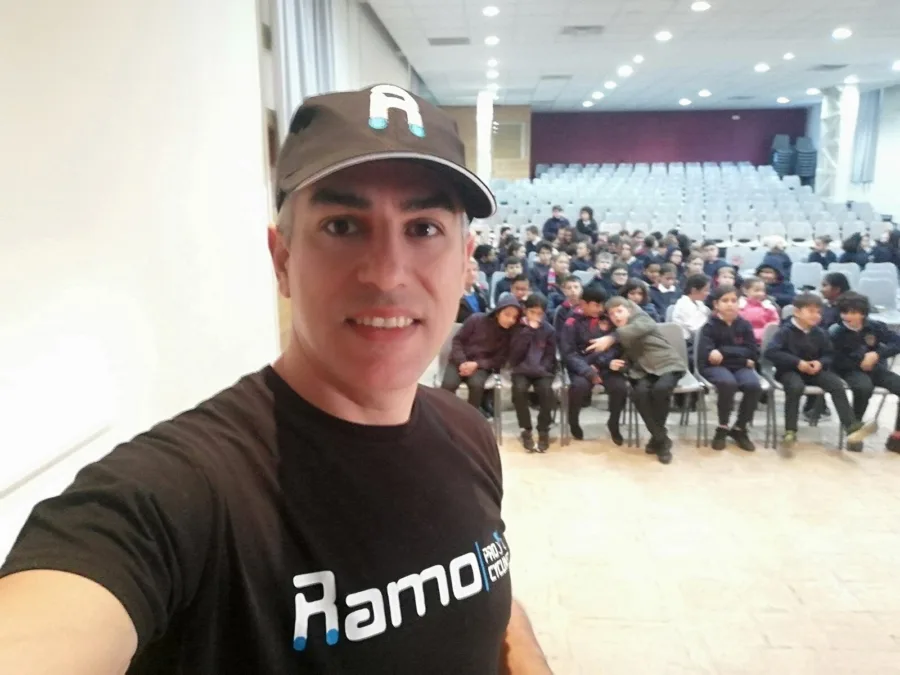 Ramo in front of a packed school auditorium before a cycling talk