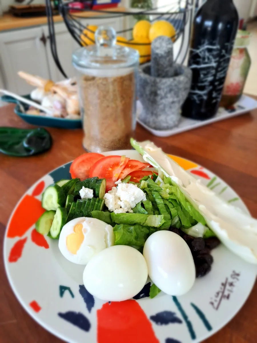 A plate of salad, boiled eggs and vegetables