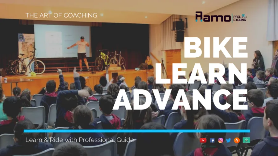 Poster: a full school hall of children facing a coach on stage between two bikes, captioned THE ART OF COACHING, BIKE LEARN ADVANCE