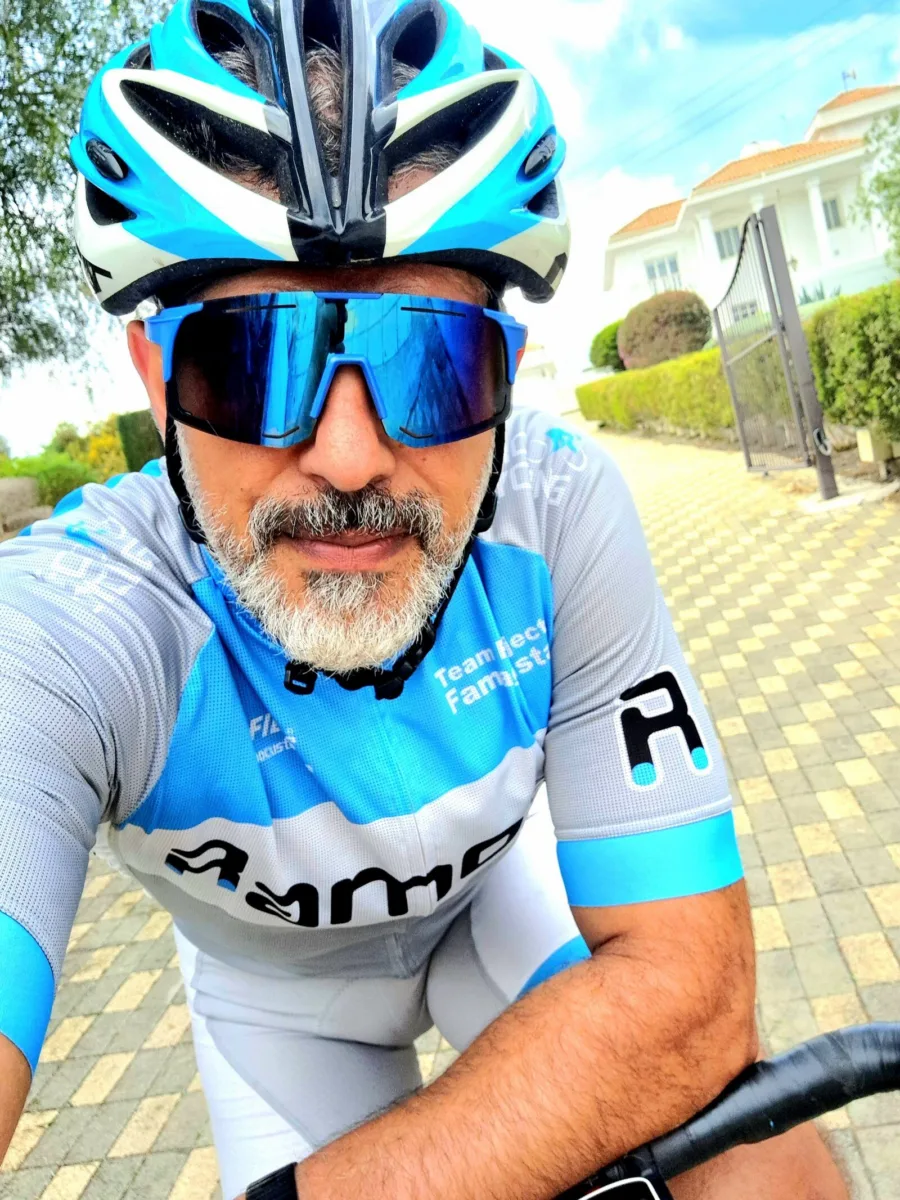 Ramo in Ramo team kit and sunglasses, sitting on a road bike before setting off