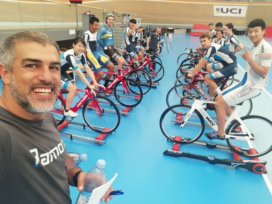 Ramo with riders warming up on turbo trainers at a velodrome