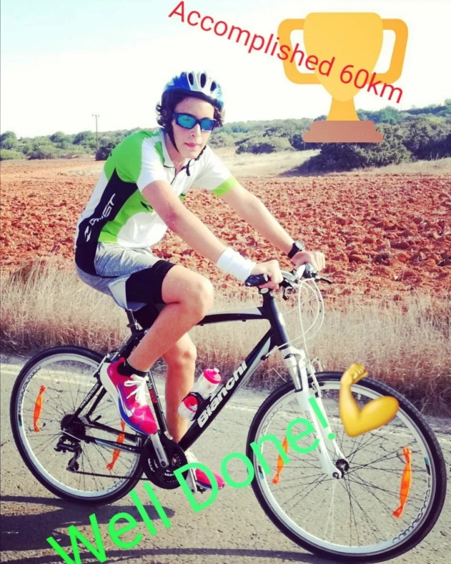 A shared story: a young rider on a flat-bar bike on a country road, captioned Accomplished 60km, Well Done!