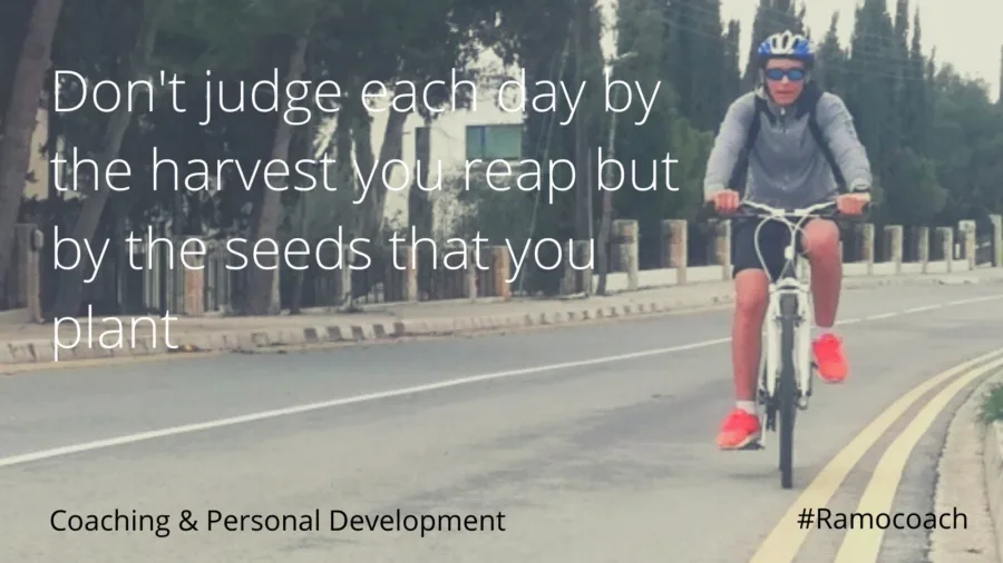Card over a photograph of a cyclist on an open road: don’t judge each day by the harvest you reap but by the seeds that you plant