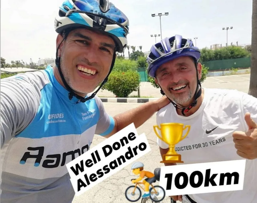A shared story: a coach and a rider grinning after a ride, captioned Well Done Alessandro, 100km