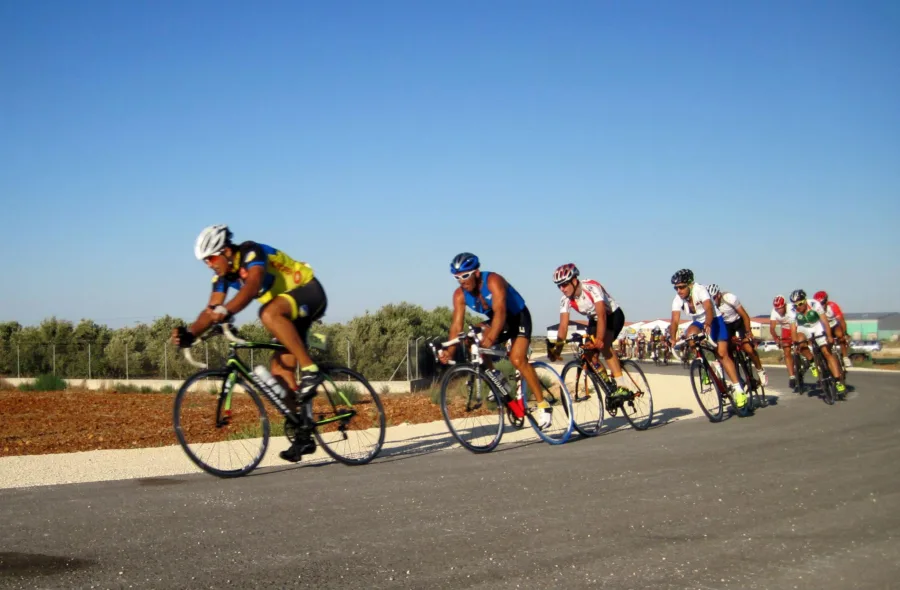 Riders racing in a line on an open road