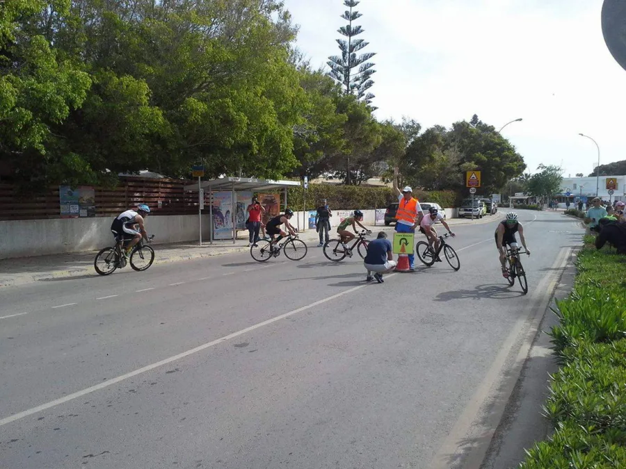 Riders spread along a road during the bike leg of a triathlon
