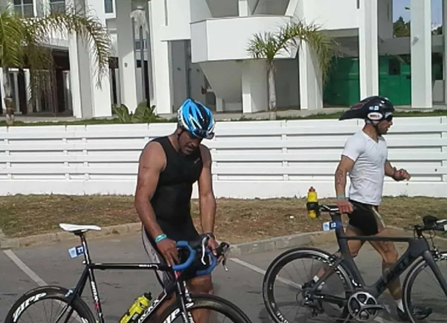 Two athletes with their bikes on a road before a race
