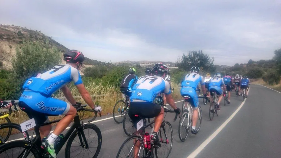 Riders in Ramo kit riding in a line on an open road