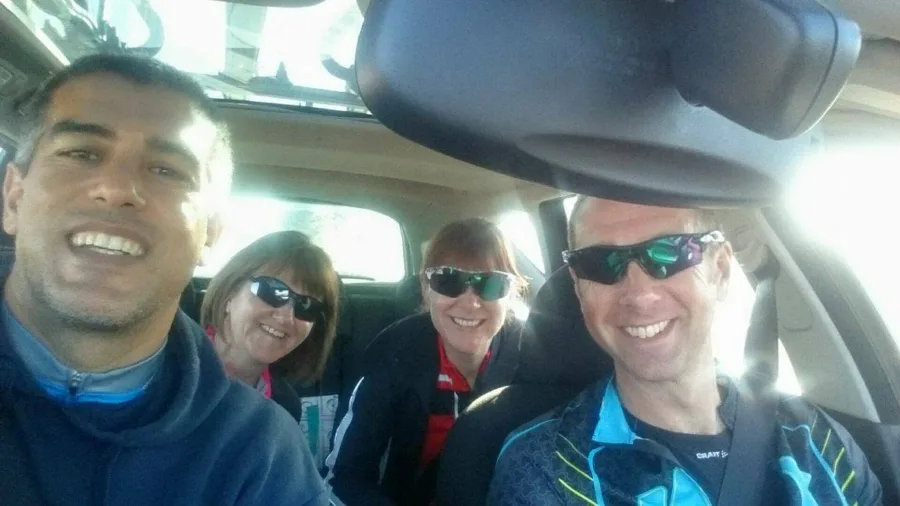 Four people in cycling kit in a car before a ride