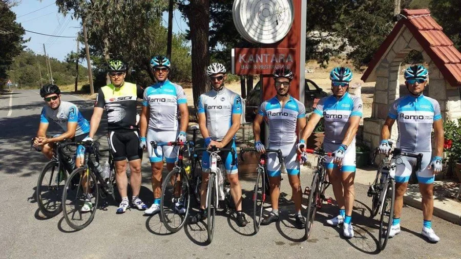 A group of riders with their bikes in front of a stone building