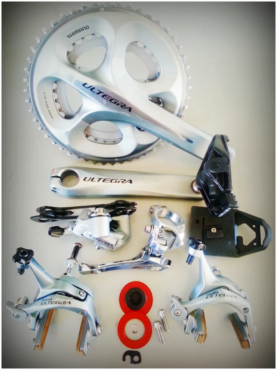 A complete Shimano Ultegra groupset laid out in parts on a floor before a build
