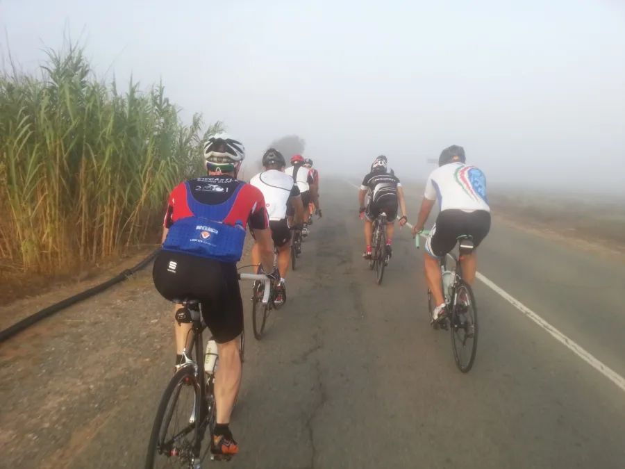 Riders on a road disappearing into thick fog