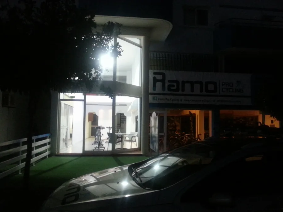 The lit shopfront of Ramo Pro Cycling at night