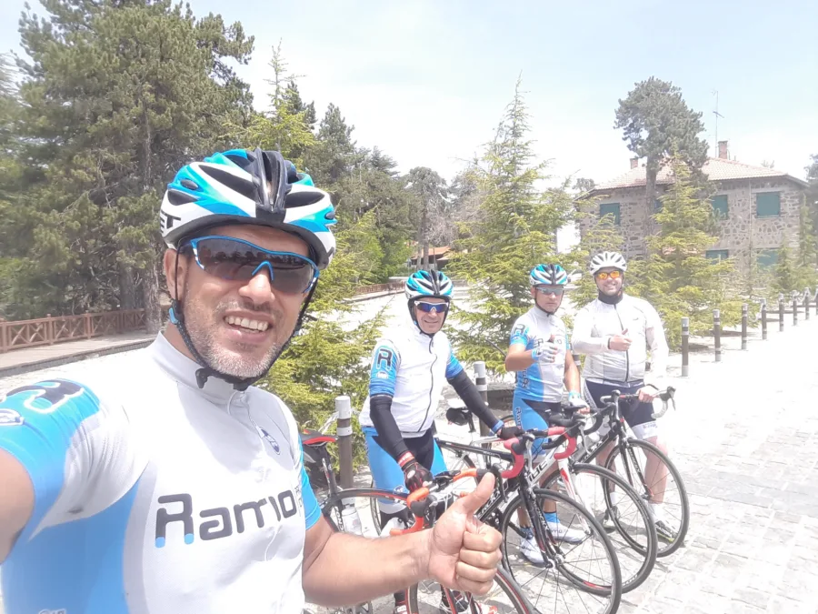 A selfie of riders in Ramo kit stopped on a road, one giving a thumbs up