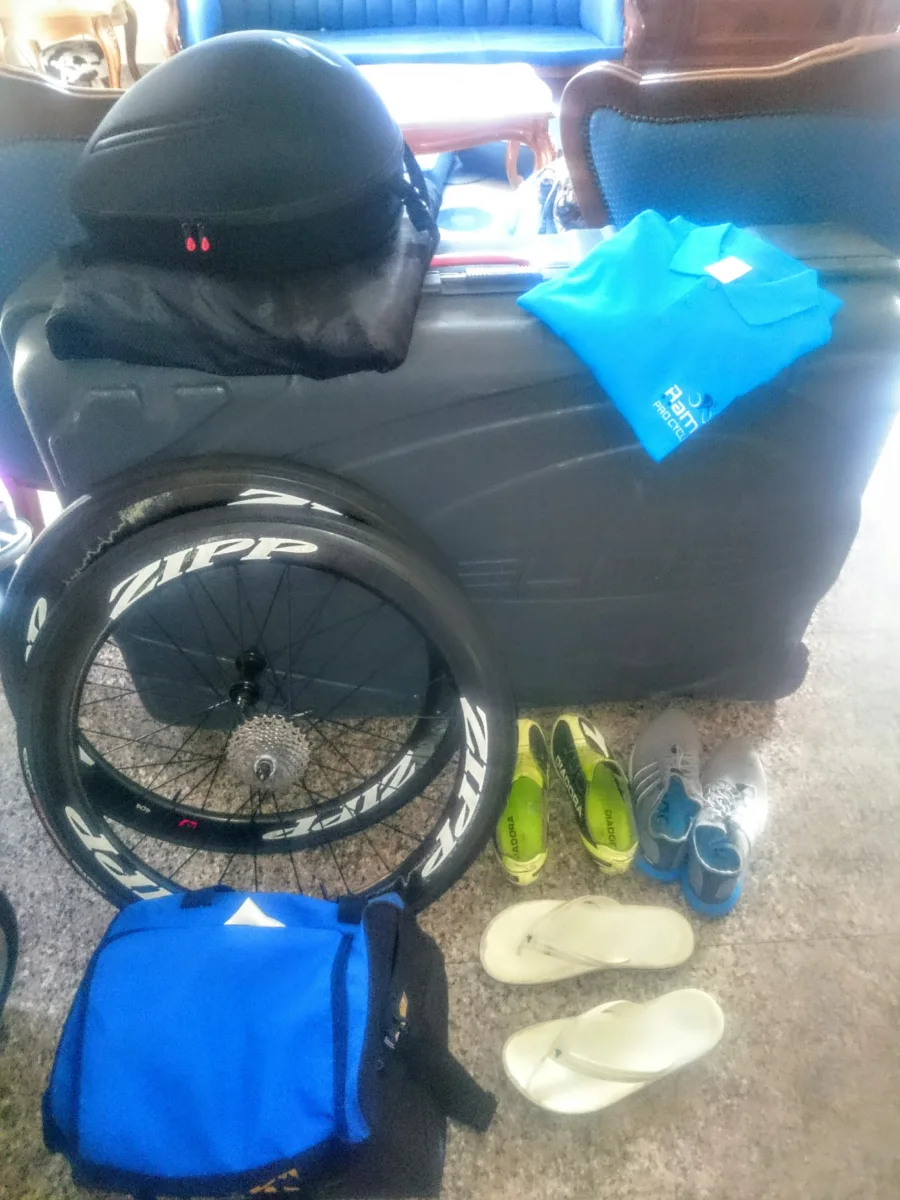 A bike bag, wheels, shoes and a kit bag laid out ready to travel
