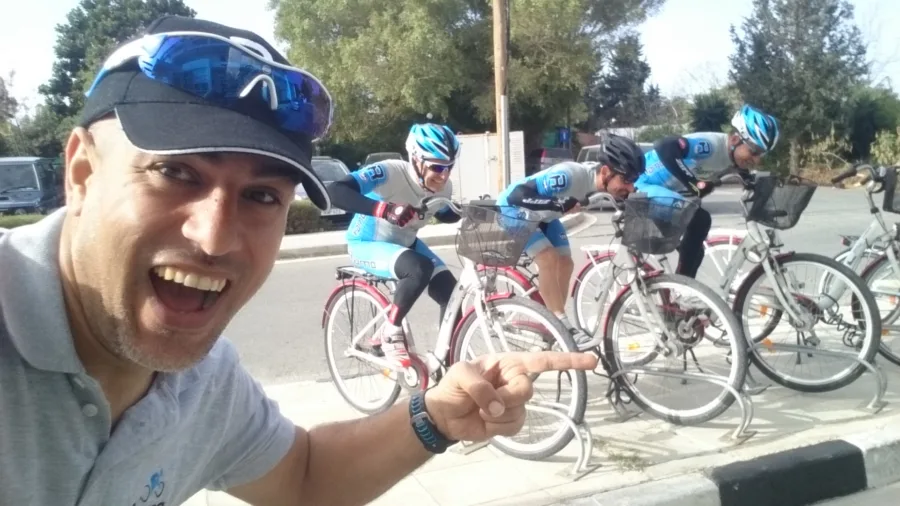 A selfie of a man in a Ramo shirt among riders and bikes on a road