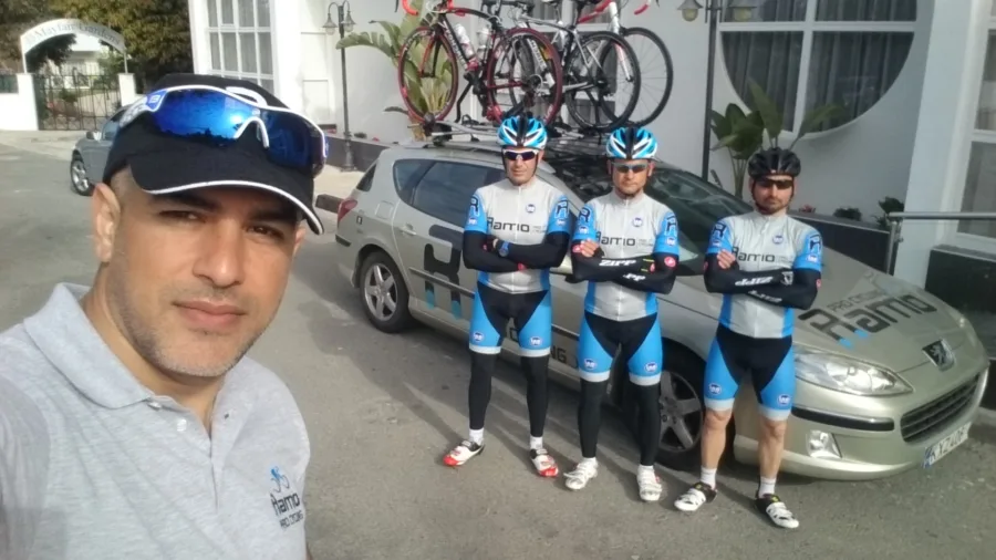 Riders in Ramo kit lined up beside the team car