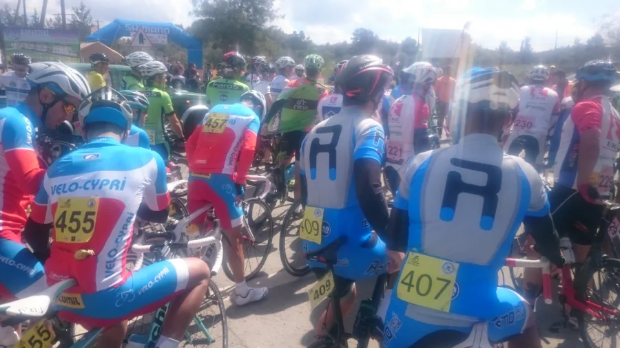 Riders with race numbers packed together before a start