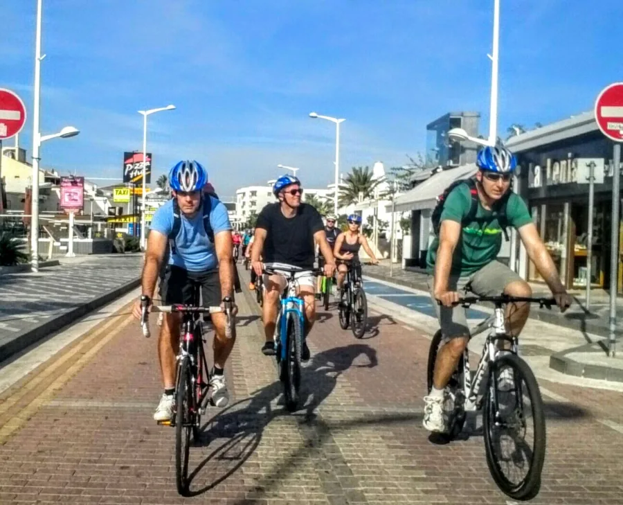Riders on mountain bikes riding through a town street