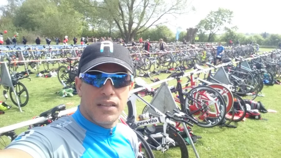 Rows of racked bikes on grass before a triathlon