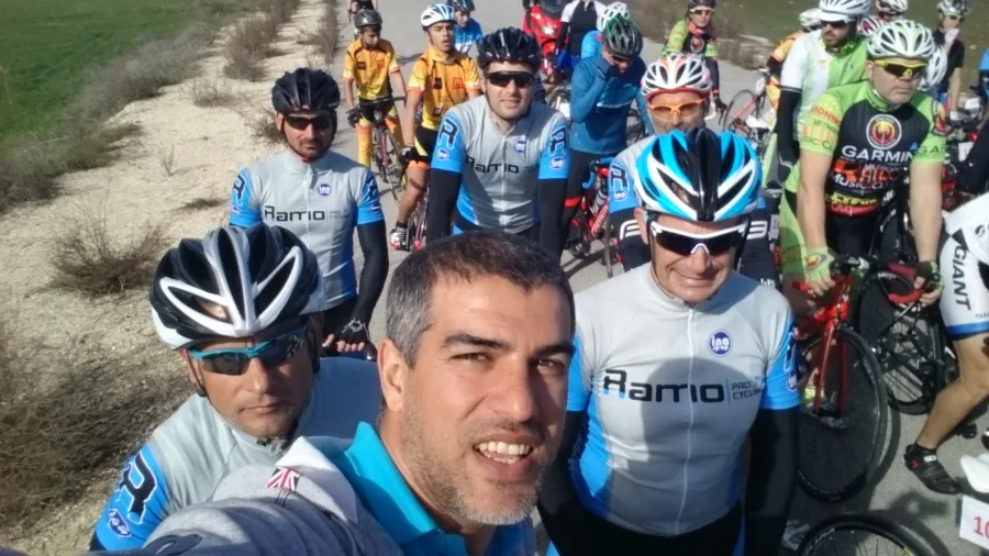 A selfie of a large group of riders in team kit before a start