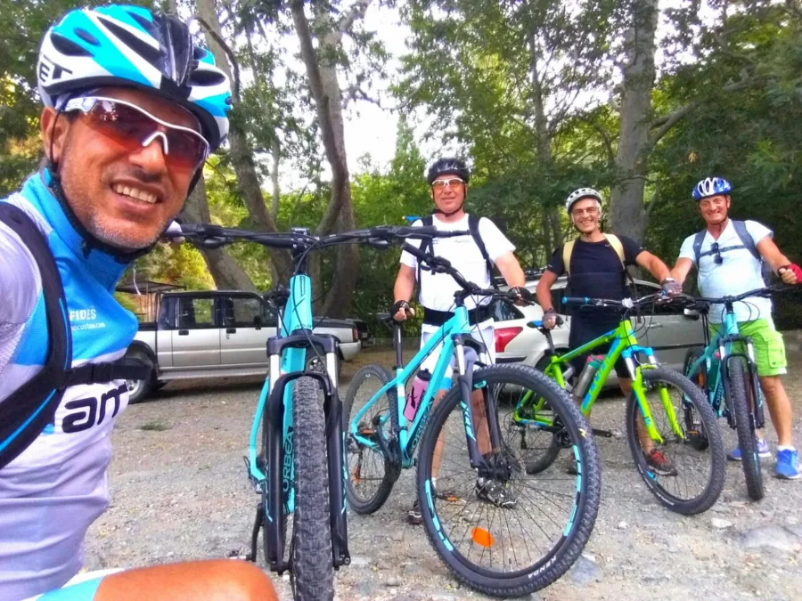 A selfie with a group of mountain bikers stopped on a gravel track