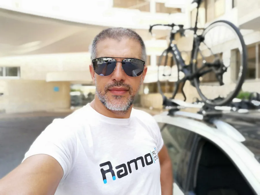 A selfie beside the team car with a bike on the roof rack