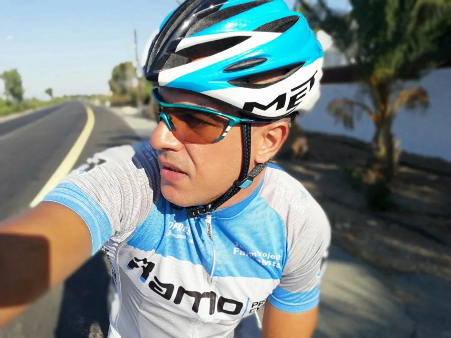 A selfie of a rider in Ramo kit riding on an open road