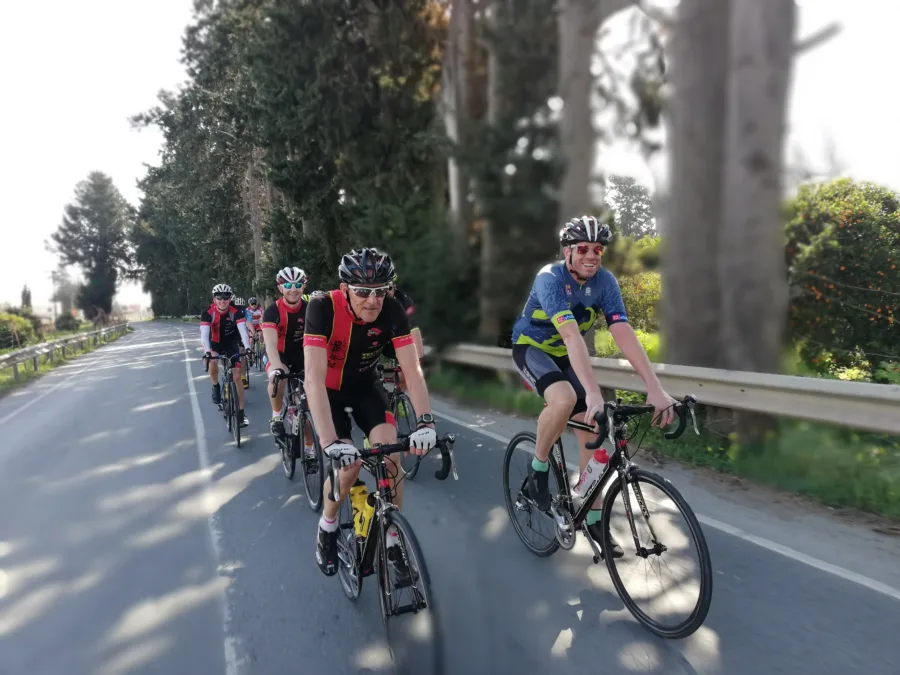Riders climbing a road together during a training camp