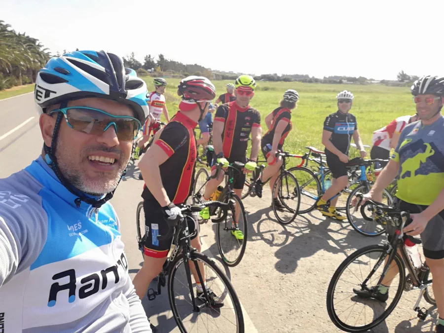 A selfie with a group of riders stopped on an open road