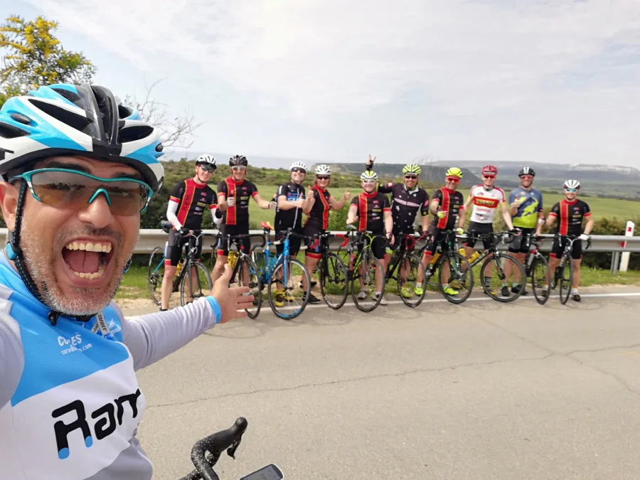 A selfie with a long line of riders and bikes on a road